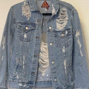 Distressed boutique jean jacket with studs